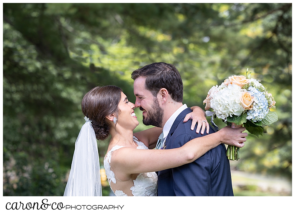 a dark-haired bride and groom embrace during their Maine wedding day first look at the colony hotel Kennebunkport maine