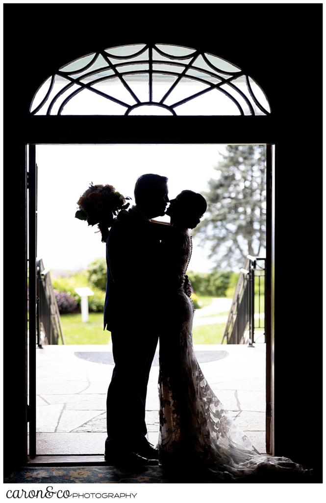 a silhouette of a bride and groom embracing in the doorway of the colony hotel Kennebunkport Maine