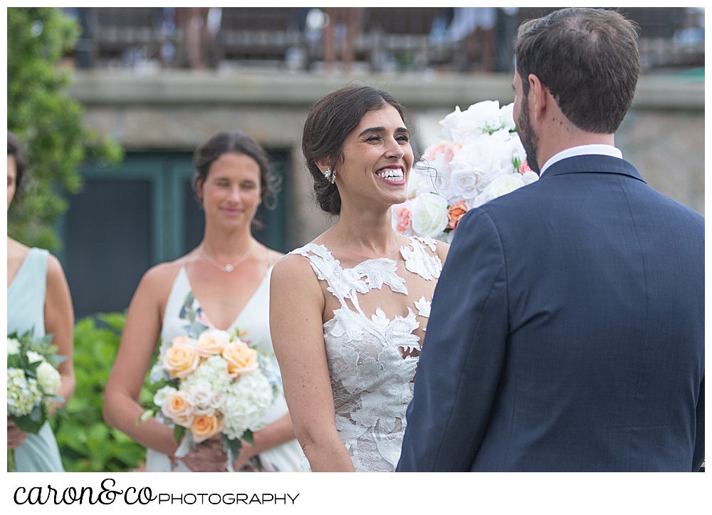 a bride smiles at her groom during an outdoor coastal maine wedding at the colony hotel Kennebunkport maine