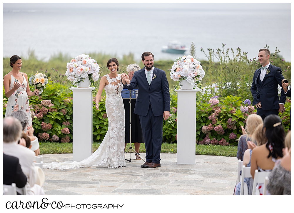 a bride and groom start their recessional during an outdoor coastal Maine wedding at the Colony Hotel, Kennebunkport Maine