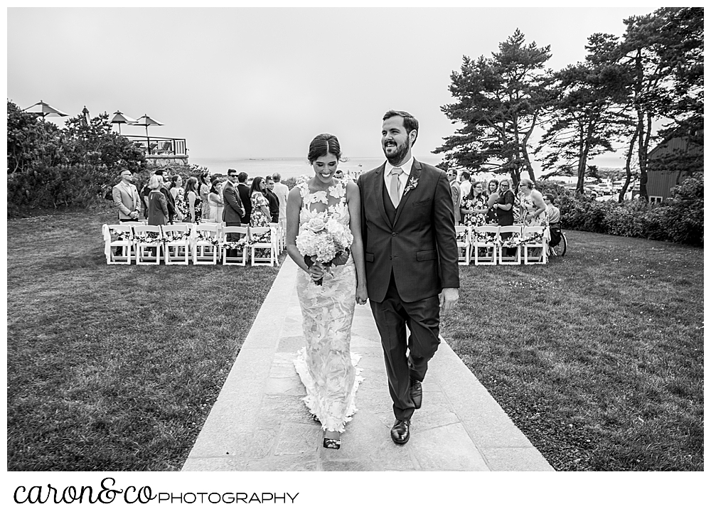 black and white photo of a bride and groom as they end their recessional at a coastal maine wedding at the colony hotel Kennebunkport maine