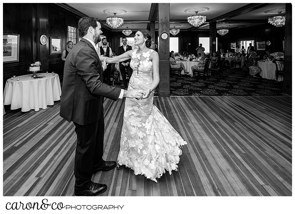 black and white photo of a bride and groom dancing their first dance