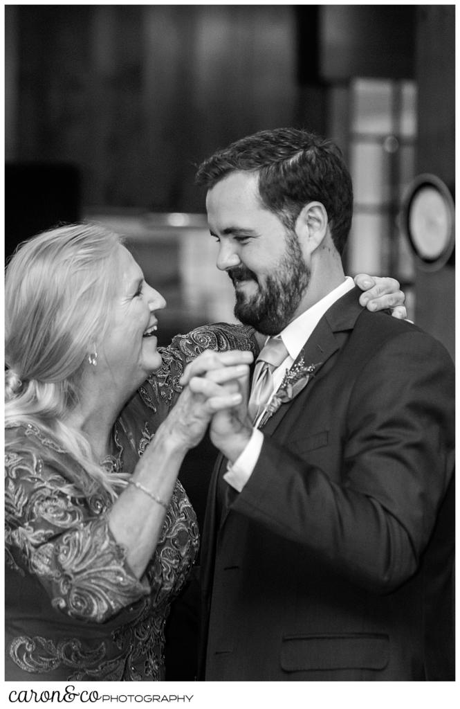 black and white photo of a groom dancing with his mother