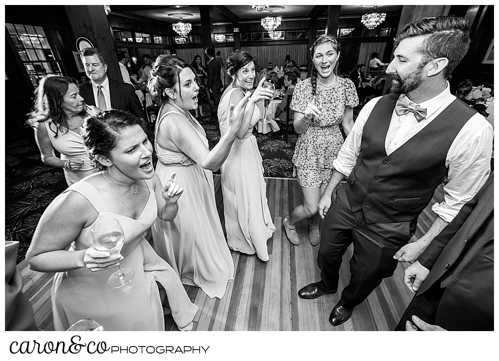 black and white photo of bridesmaids dancing at a coastal Maine wedding at the Colony Hotel Kennebunkport Maine