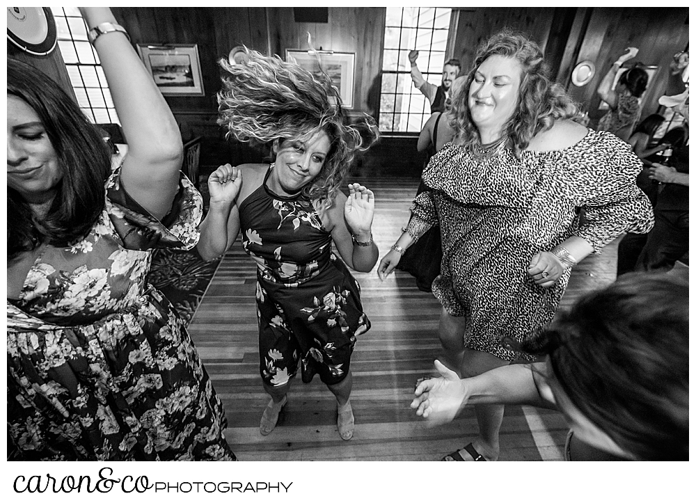 black and white photo of women dancing, one of them has her hair flying around her head