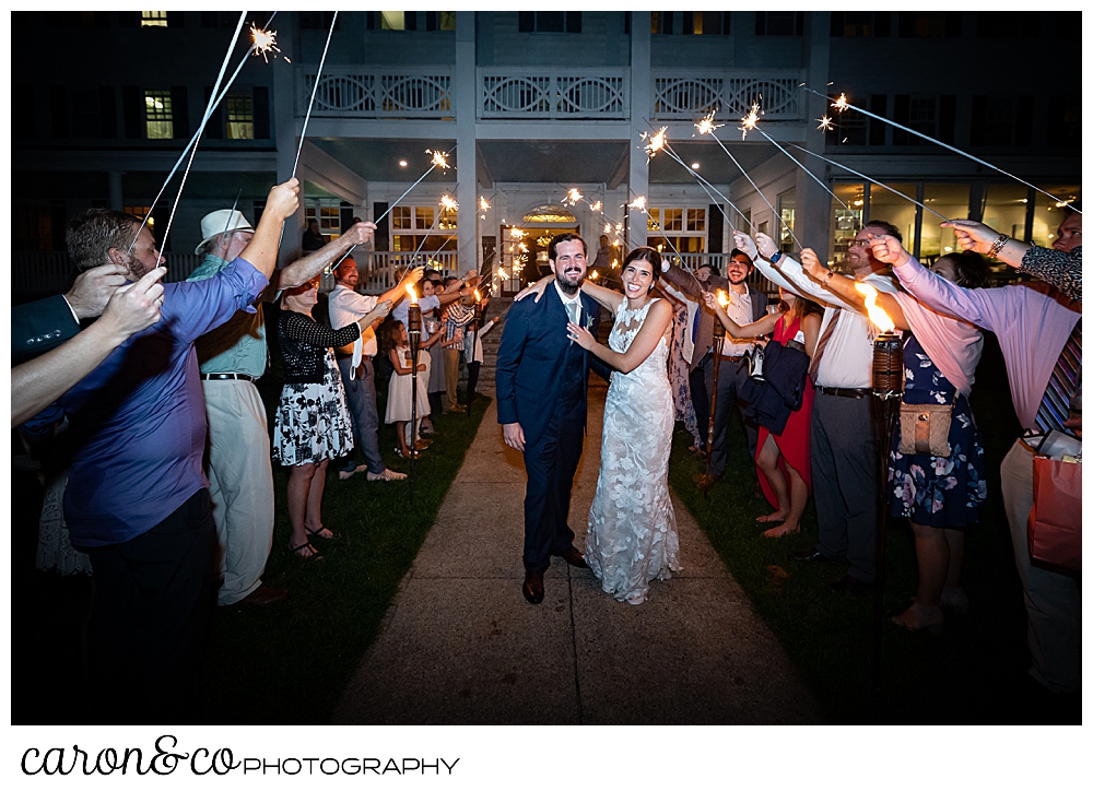 a bride and groom walk through a sparkler exit on coastal Maine wedding at the Colony Hotel Kennebunkport Maine