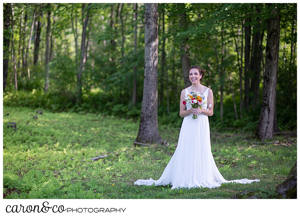 a bride smiles during her Maine wedding day first look