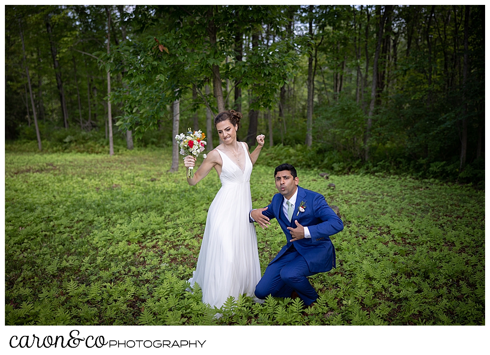 a bride and groom dance in the woods