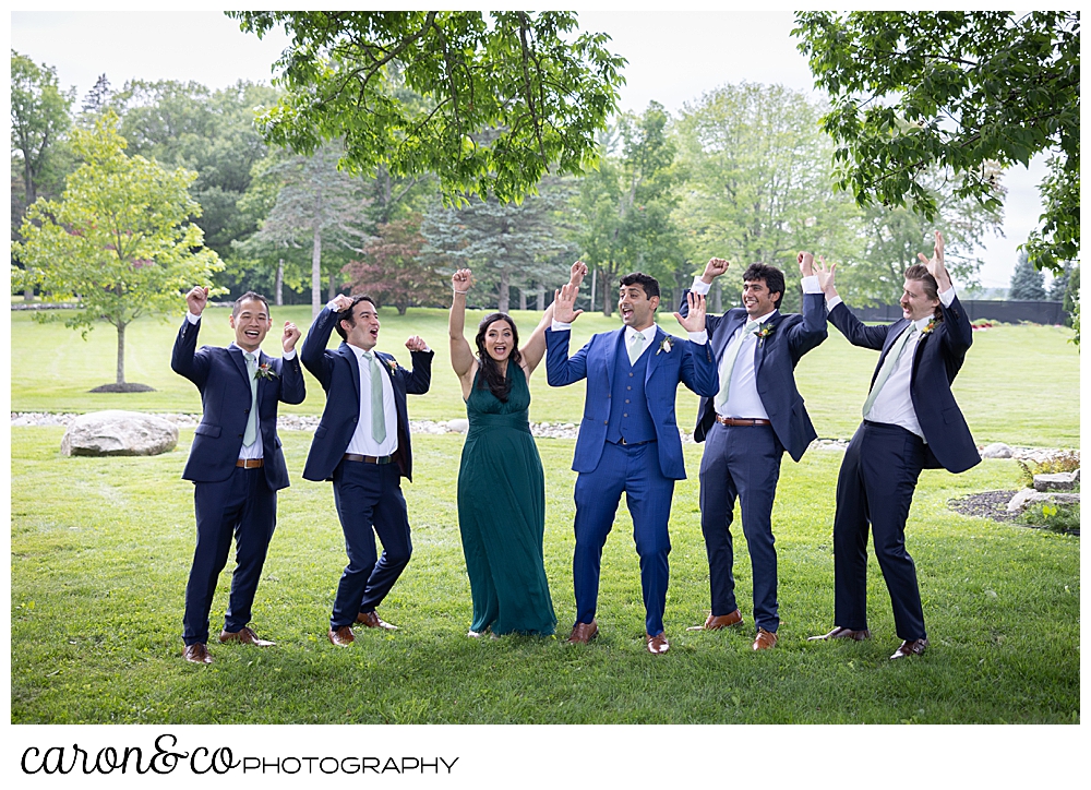 a groom and 4 groomsmen, and 1 groomswoman cheering at a joyful Pineland farms wedding