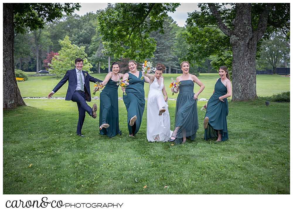 a bride, 4 bridesmaids, and a bridesman dance in a line