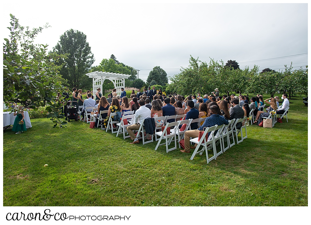 wide view of a joyful Pineland farms wedding ceremony in the garden