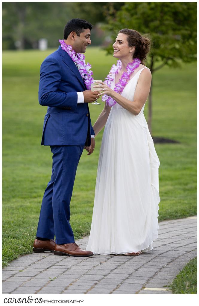 a bride and groom are standing on a walkway, just before entering their Pineland Farms wedding reception