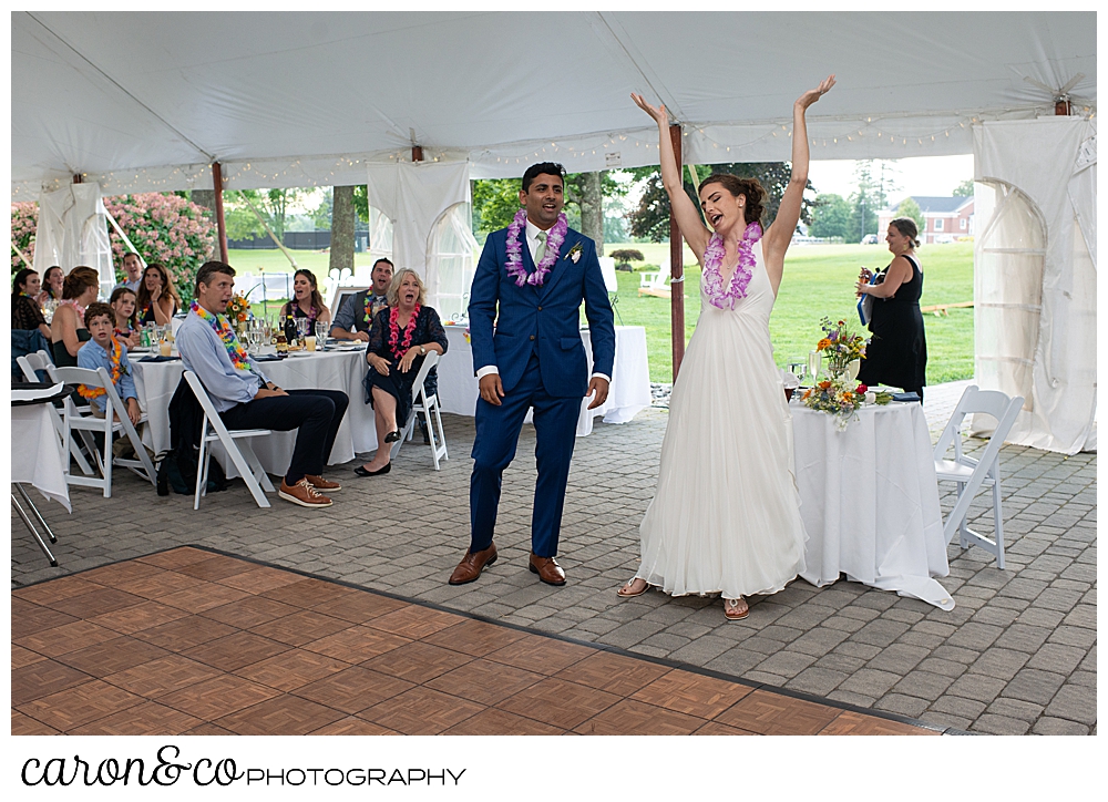 a bride and groom enter their joyful Pineland Farms wedding reception under a tent