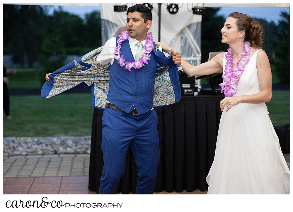 bride and groom during their first dance and the groom starts taking off his jacket