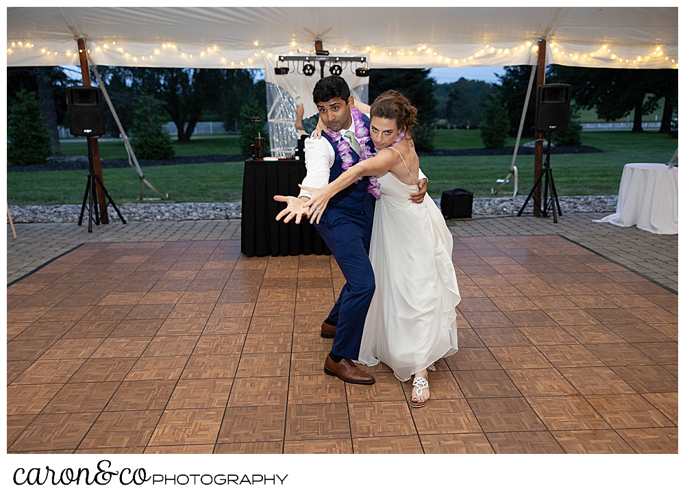 a bride and groom dance during the first dance in a tango pose