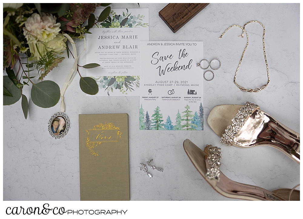 wedding day details in a flat lay, bouquet, paper suite, jewelry, rings, bridal shoes