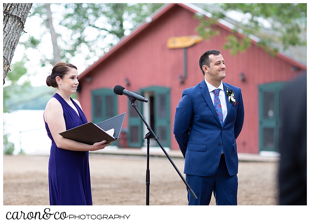 a groom and an officiant stand at the head of the aisle at Kingsley Pines