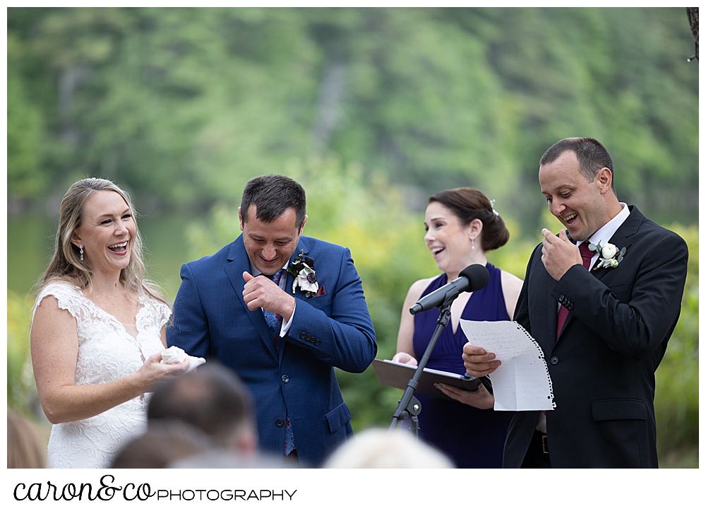 a bride and groom stand side by side, while an officiant stands nearby, and the brother of the groom sings a poem, they are all laughing, at a Kingsley Pines Maine wedding ceremony