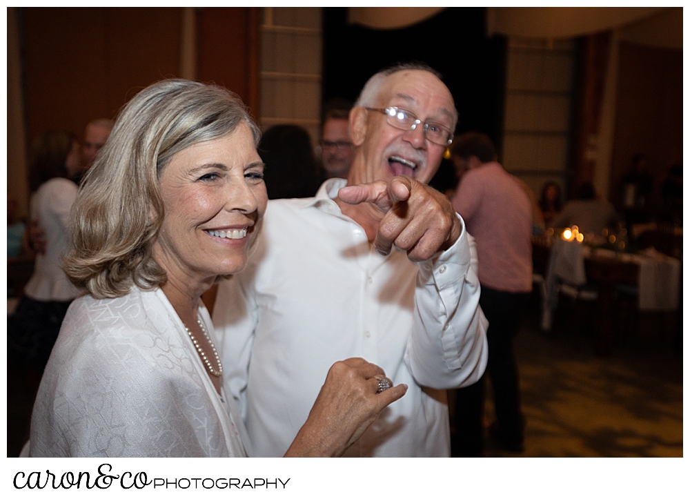 a woman and man dancing, the man is pointing at the camera