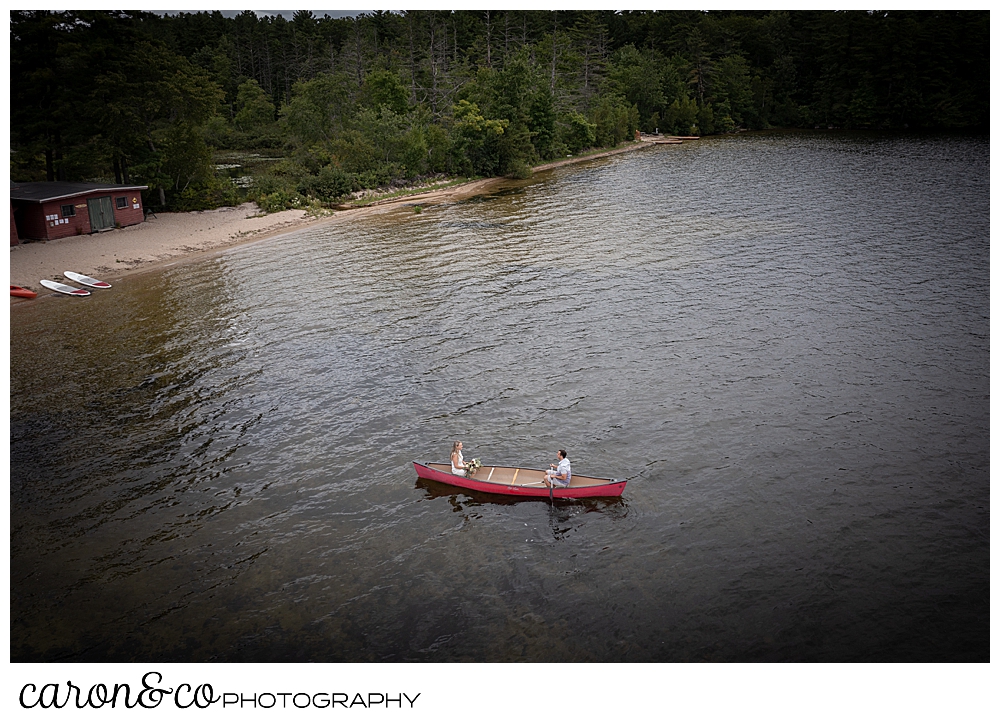a drone photo of a couple in a red canoe at Kingsley Pines, Raymond, Maine
