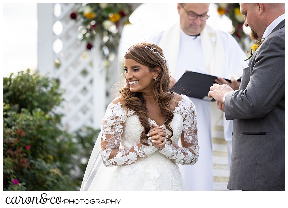 a bride, turns during her wedding ceremony, to smile