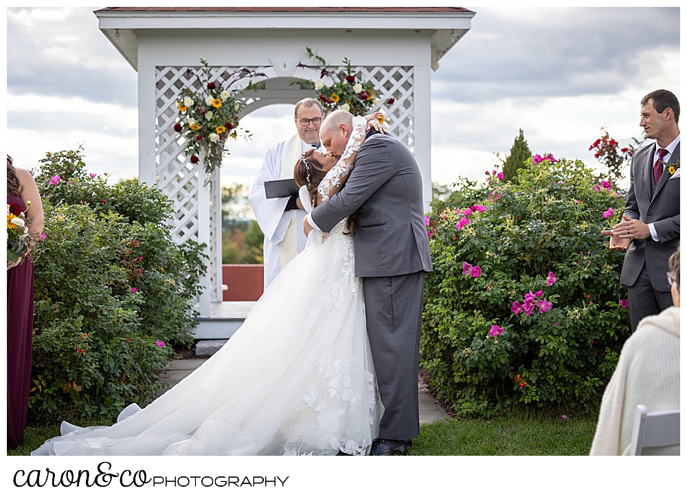 a bride and groom kiss at a wedding at Maine wedding barn in Minot Maine