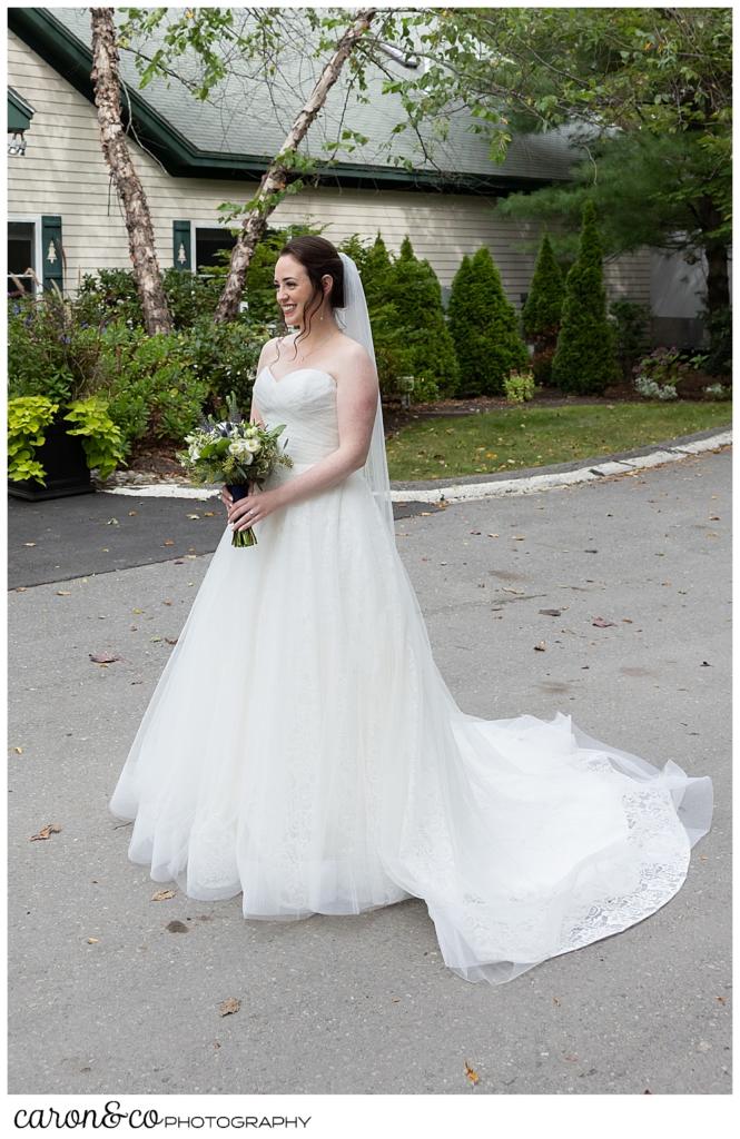 a bride stands near the Pemaquid Room at the Spruce Point Inn, for a first look with her father
