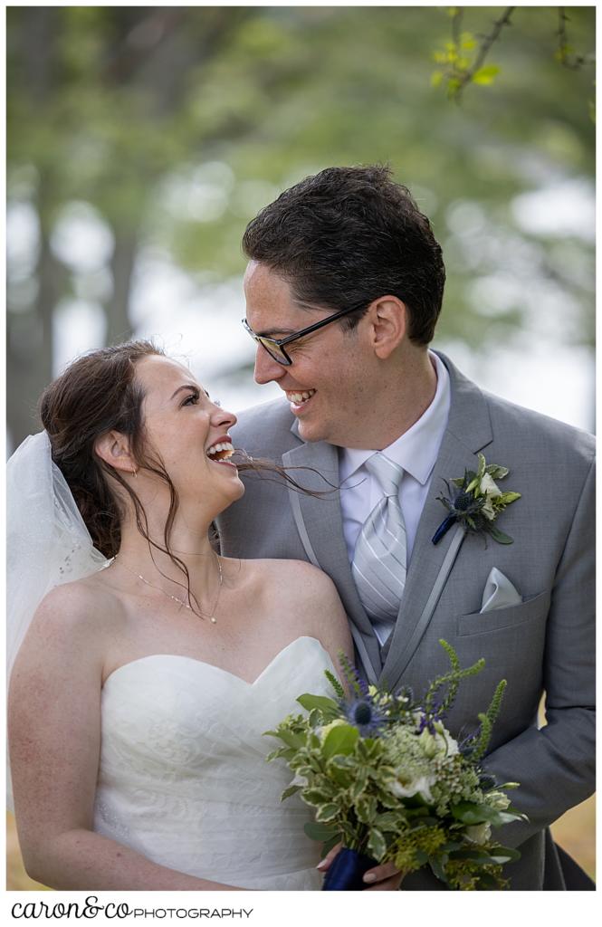 a bride and groom, standing side by side, smile at one another during their wedding day first look