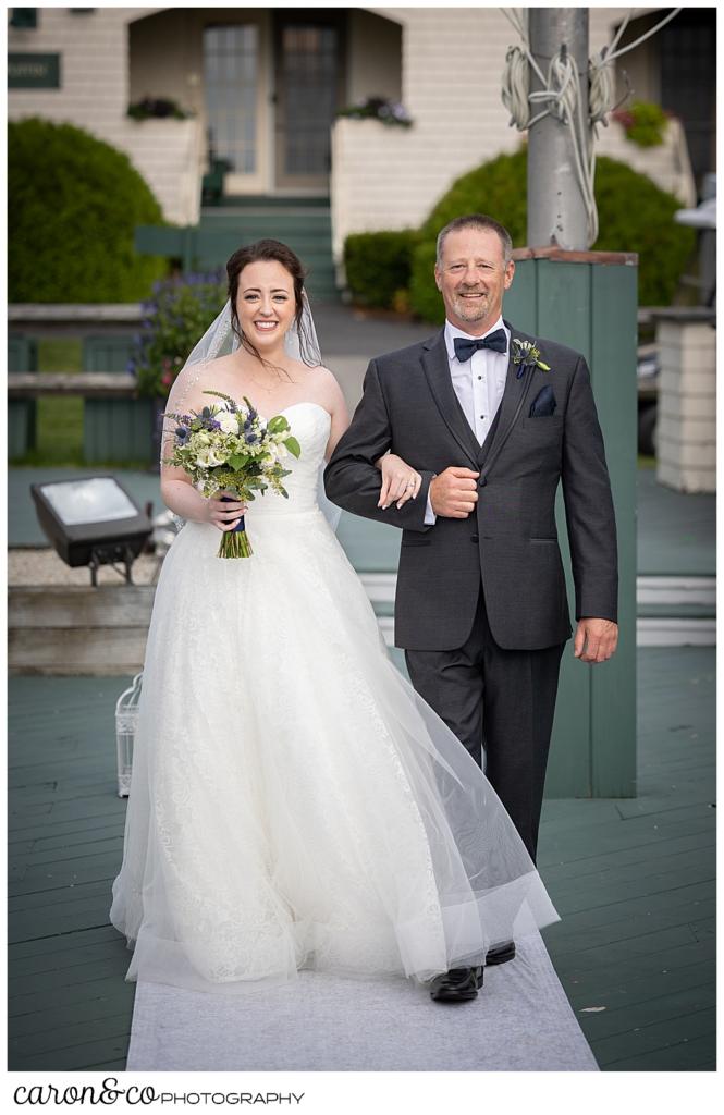 a bride and her father approach the ceremony site on the deck at the Spruce Point Inn, Boothbay Harbor, Maine