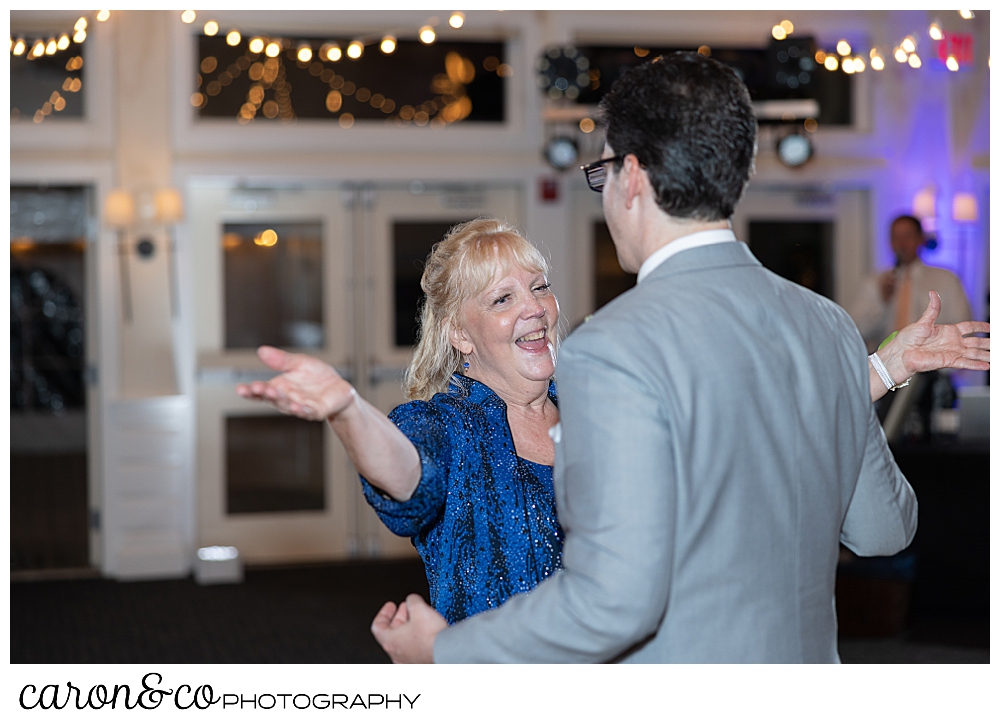 a groom and his mother dance the mother son dance at a Spruce Point Inn Maine wedding reception
