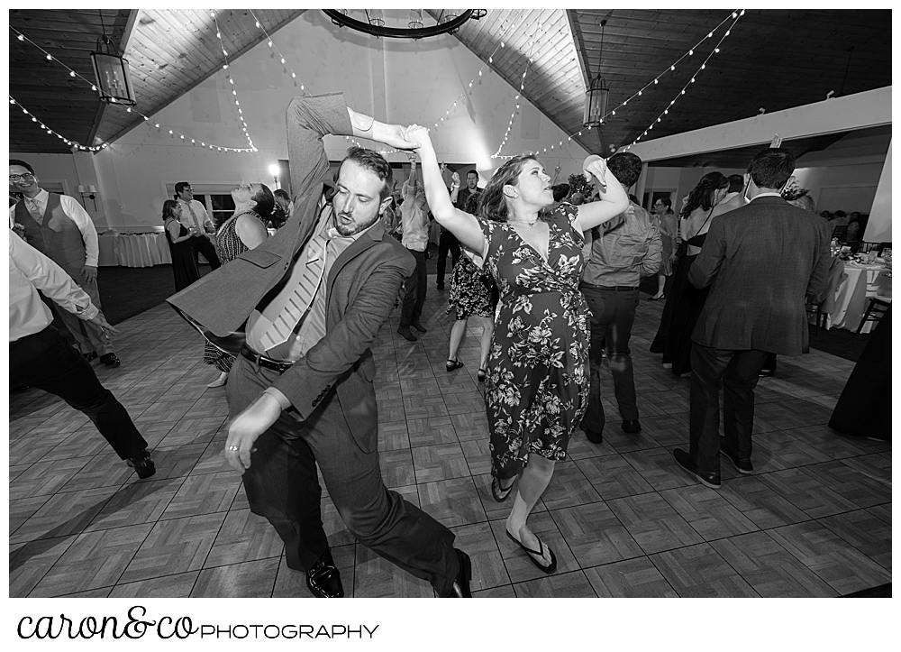 black and white photo of wedding guests dancing at a wedding reception