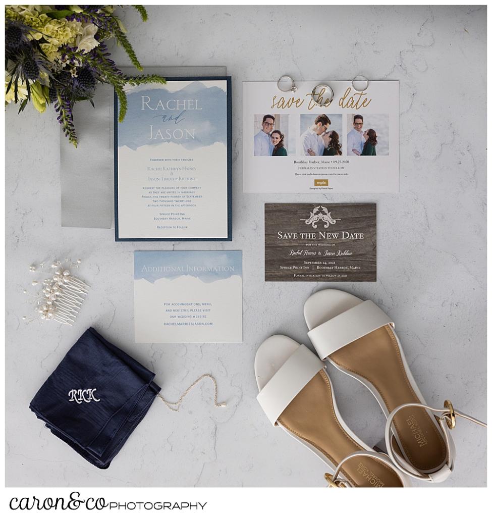 wedding day details in a flat lay, including bridal shoes, paper suite, bridal bouquet, a handkerchief, and wedding bands