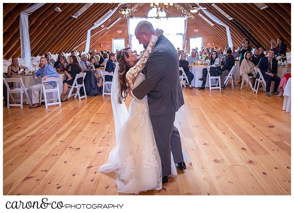 a bride and groom dance their first dance at a Maine wedding barn wedding in Minot Maine