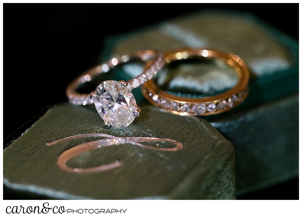 a bride's diamond wedding band and engagement ring, atop a the Mrs. Box ring box