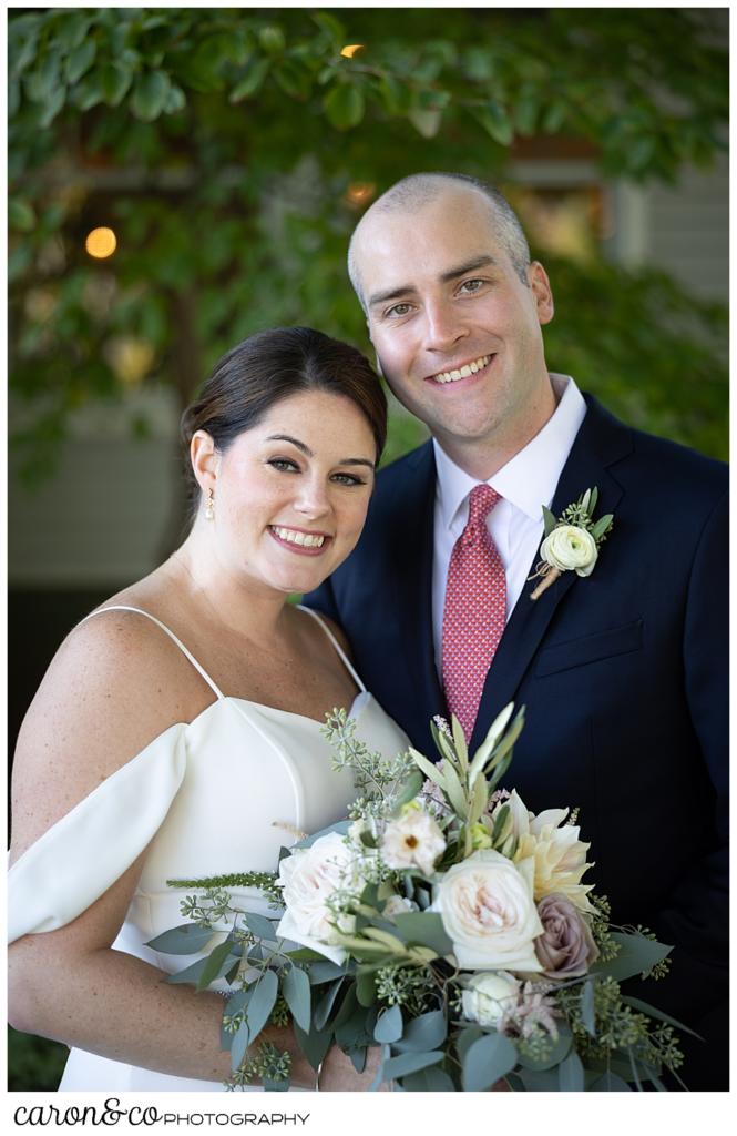 a bride and groom portrait of a bride wearing a white dress, and a groom wearing a navy suit