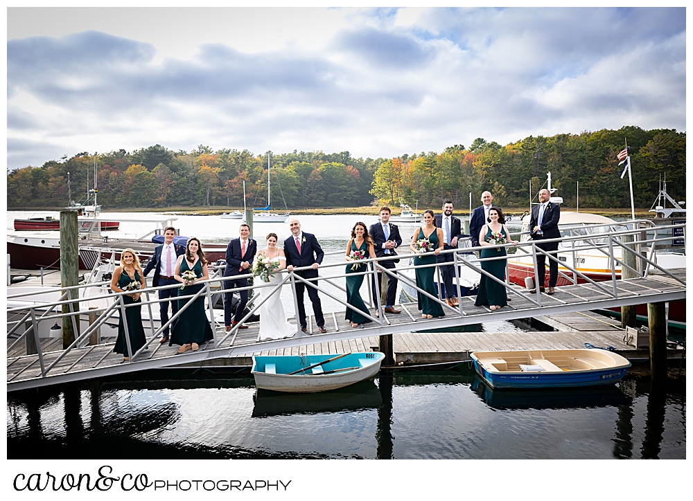 a bride and groom and their bridal party, stand on the ramp at The Nonantum Resort dock, Kennebunkport, Maine
