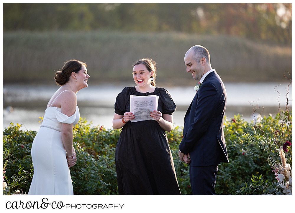a bride, groom, and officiant laugh during a Nonantum Resort Kennebunkport Maine wedding ceremony