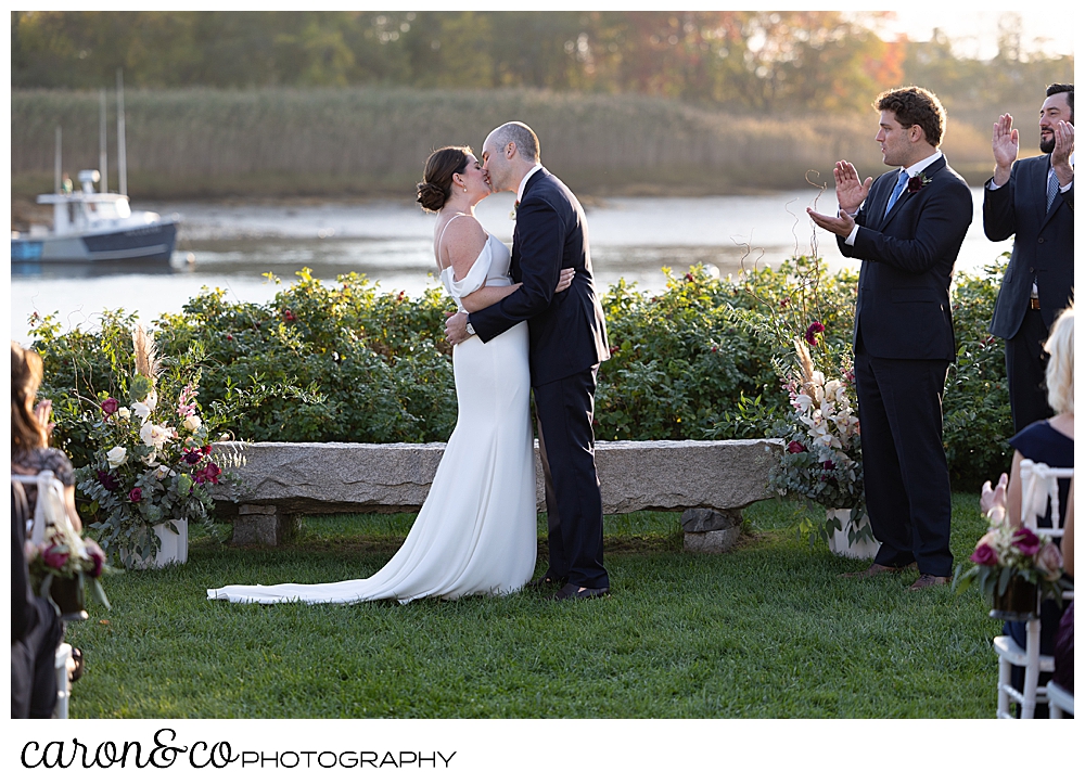a bride and groom have their first kiss at a Nonantum Resort Kennebunkport Maine wedding ceremony