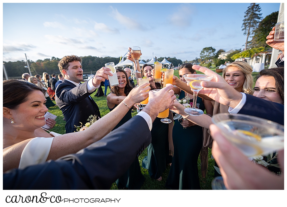 a bride and groom have a toast with their bridal party after their Nonantum Resorer Kennebunkport Maine wedding ceremony