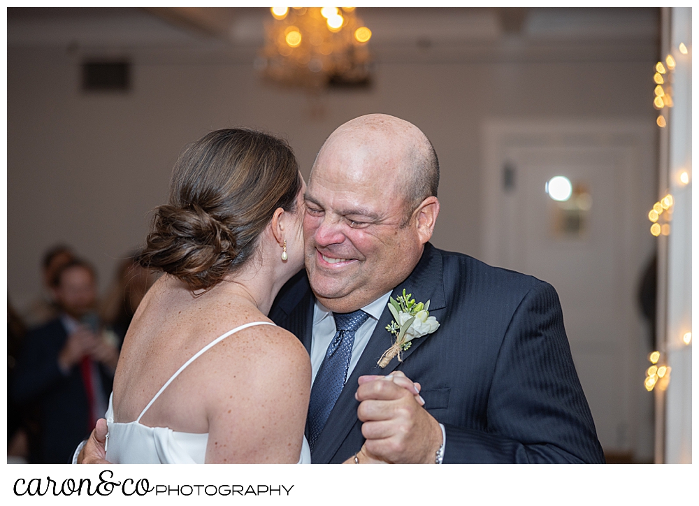 a smiling father of the bride, with tears in his eyes, dances with the bride during the father daughter dance at a Nonantum Resort Kennebunkport Maine wedding reception