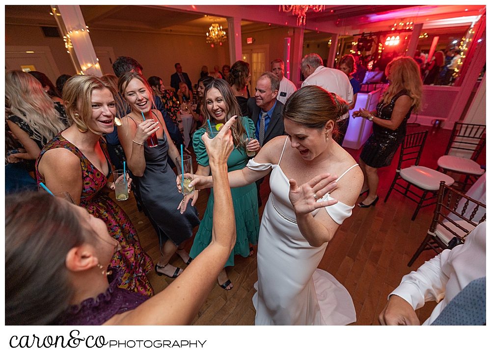 a bride dances with her friends in the ballroom at a Nonantum resort Kennebunkport Maine wedding reception