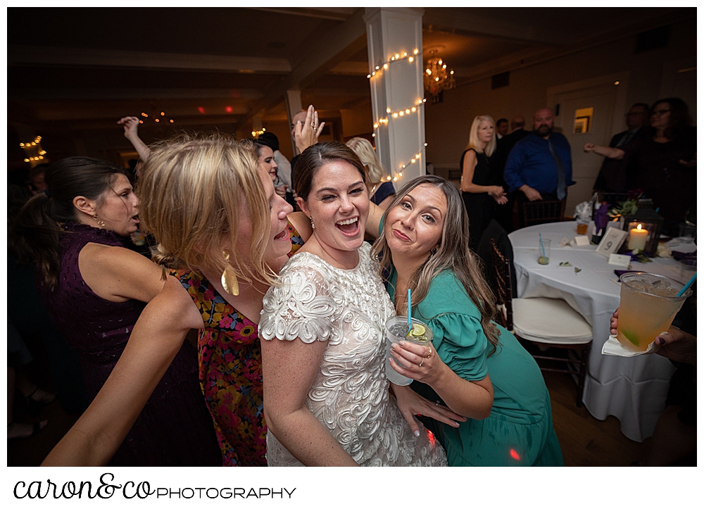 a bride dances between two friends at a Nonantum Resort Kennebunkport Maine wedding reception