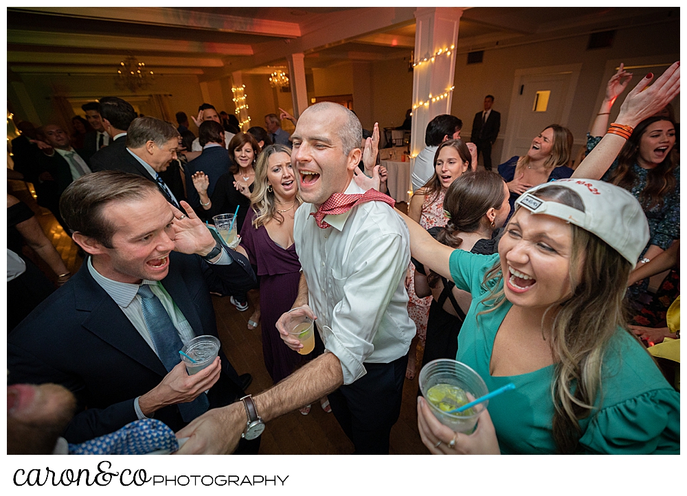 a groom dances with friends at a Nonantum Resort Kennebunkport Maine wedding reception