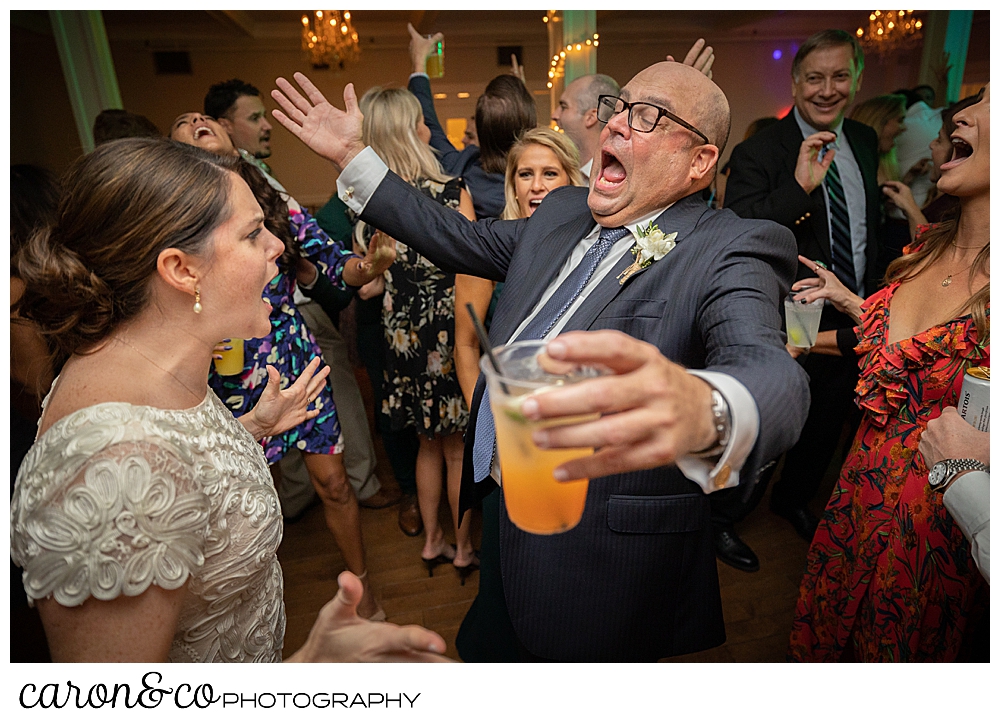 a bride dances with her dad, who is holding a drink in one hand, at a Nonantum Resort Kennebunkport Maine wedding reception