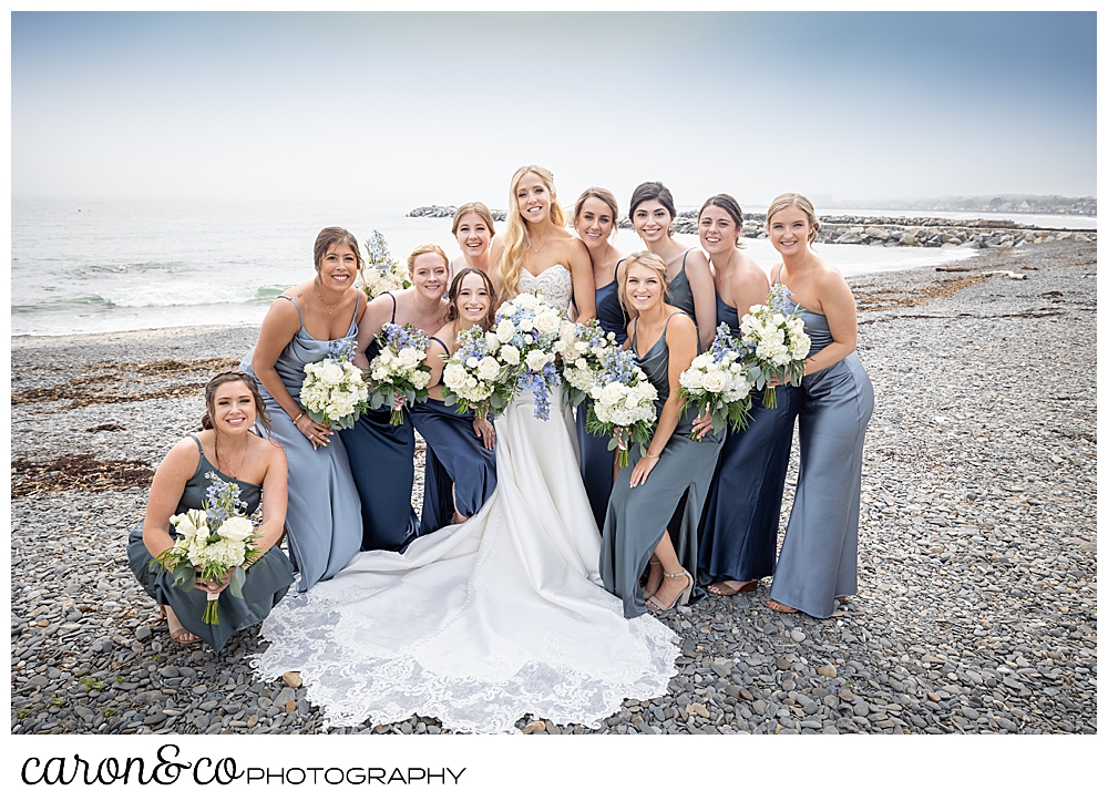 a bride is surrounded by her bridesmaids, all in various shades of blue, at Colony Beach in Kennebunkport Maine