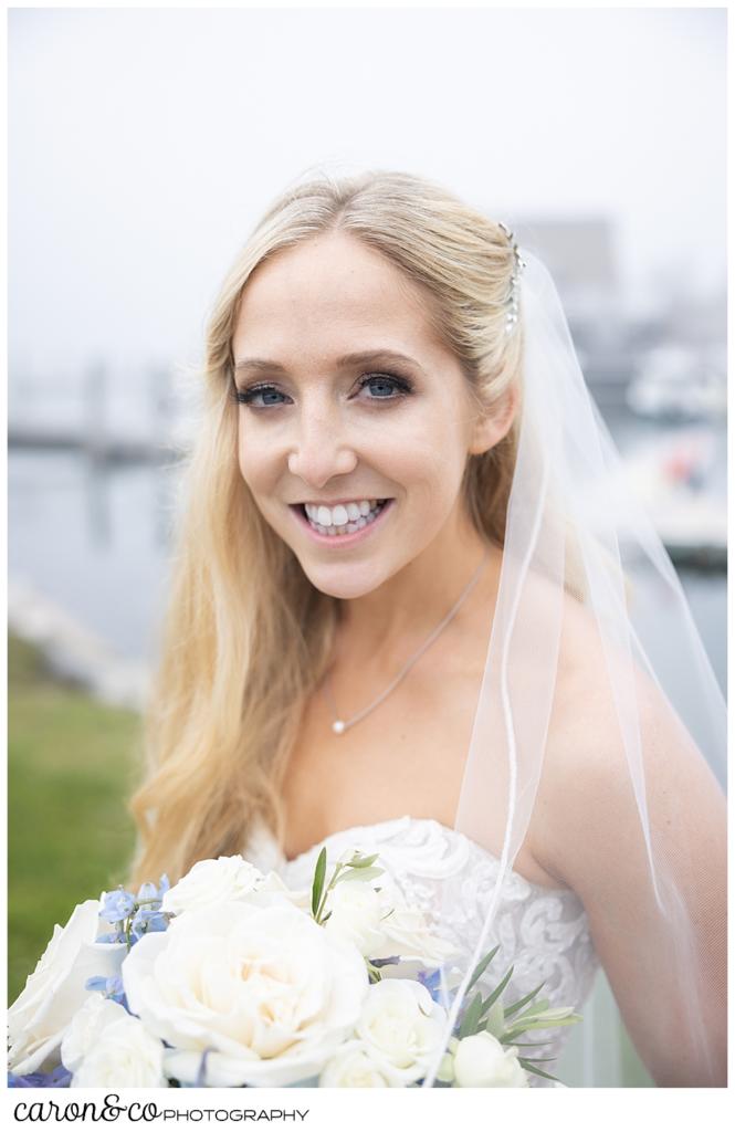 a happy smiling bride during on the shores of Kennebunkport Maine