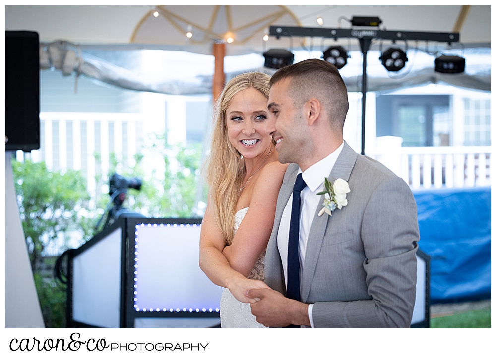 a bride and groom begin their first dance at a tented reception at a breakwater inn Kennebunkport wedding