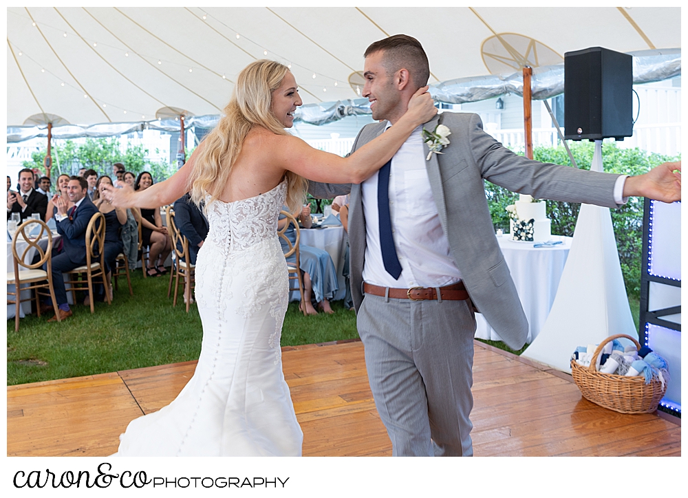 the bride and groom dance their first dance at a tented breakwater inn Kennebunkport wedding reception