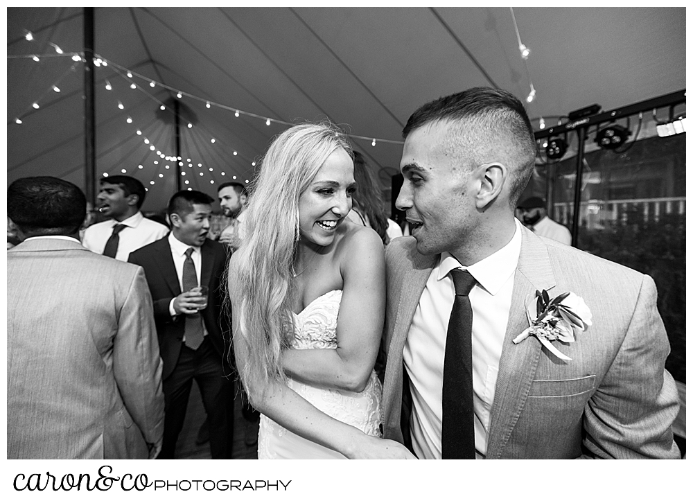 a black and white photo of the bride and groom dancing during their tented breakwater inn Kennebunkport wedding reception