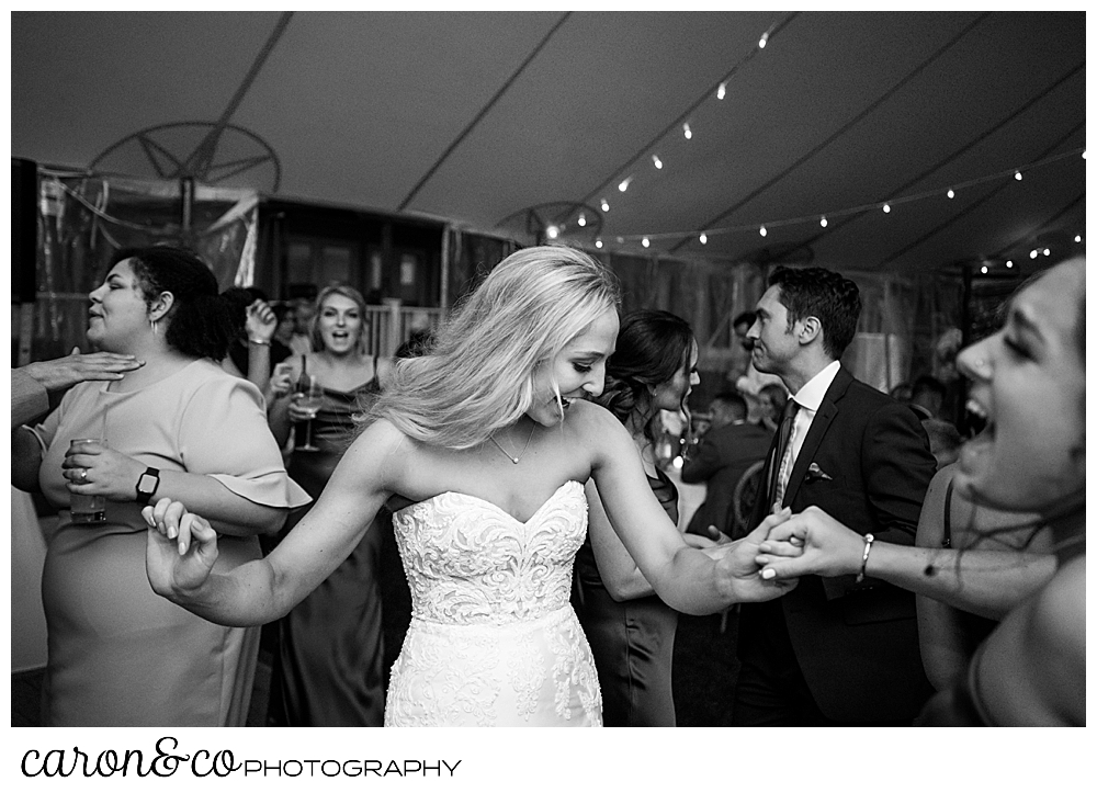 a bride dances at her tented breakwater inn Kennebunkport wedding reception